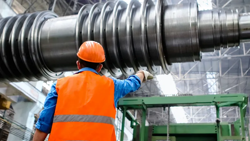 Factory worker on second shift reviewing production equipment