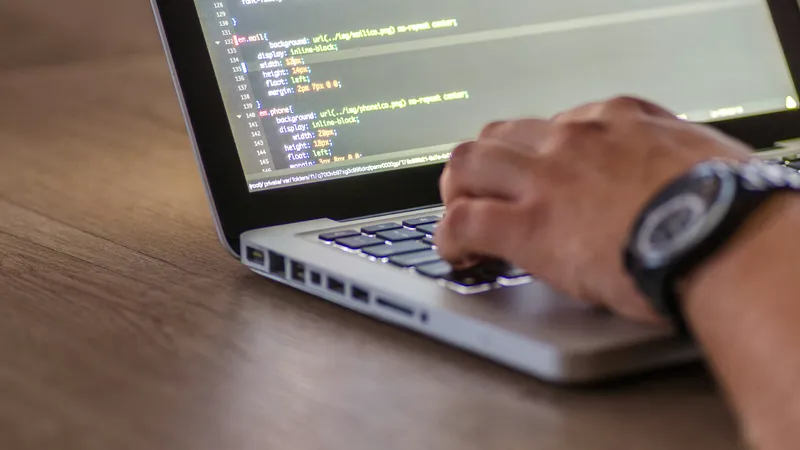 Professional coding on laptop for moonlighting freelance work