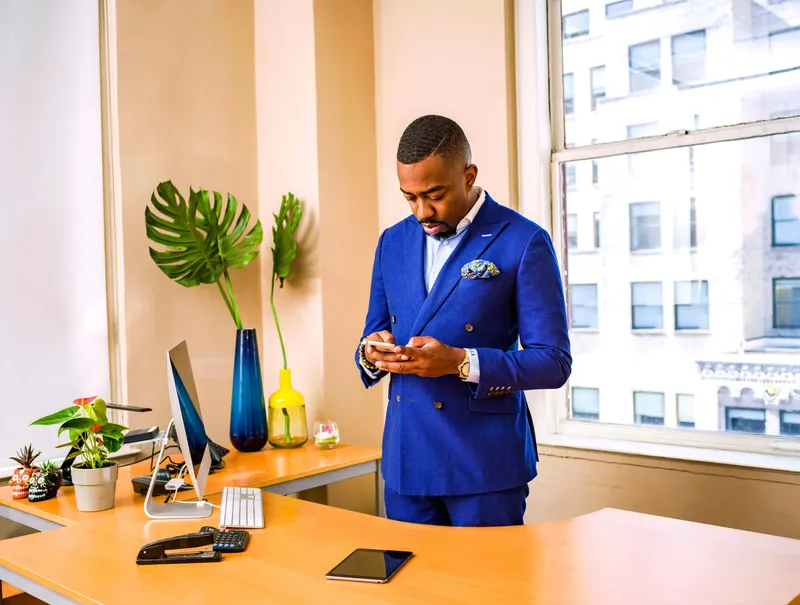 Professional using phone for business communications in full-time role